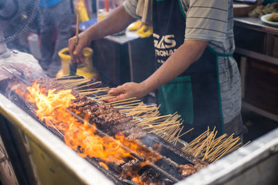 Man working on barbecue grill