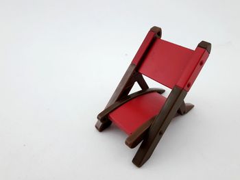 High angle view of red chair on white background
