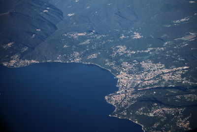 Aerial view of sea by mountain