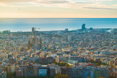 High angle view of buildings by sea against sky