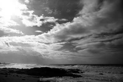 View of calm sea against cloudy sky