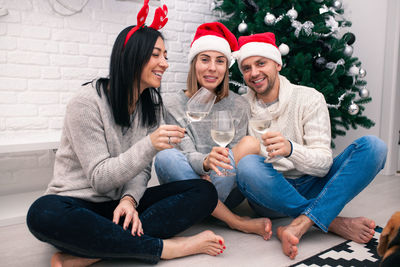 Woman sitting on sofa in living room