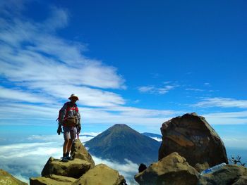 Man on snowcapped mountain against sky