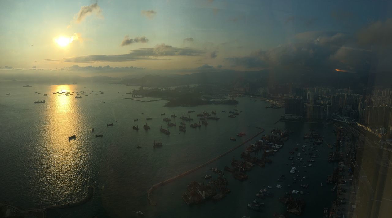 HIGH ANGLE VIEW OF BEACH AGAINST SKY AT SUNSET