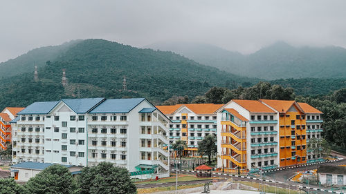 Houses and mountains against sky