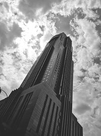 Low angle view of buildings against cloudy sky