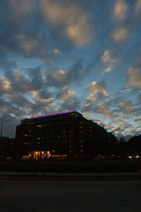 Low angle view of buildings against sky at sunset