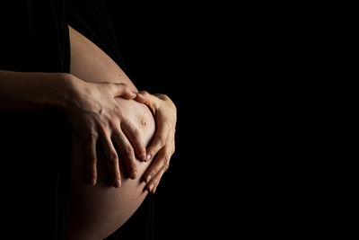 Close-up of hand against black background