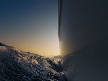 Close-up of mountains against clear sky during sunset