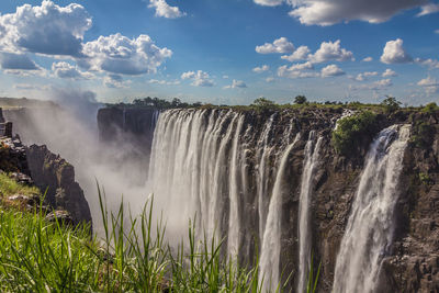 Panoramic view of waterfall against sky