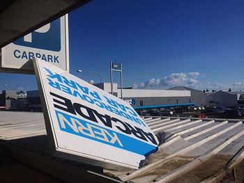 Information sign against blue sky