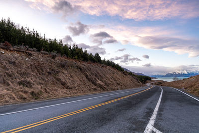 Mount cook road alongside lake pukaki with snow capped southern alps in winter evening light. 