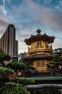 View of temple building against cloudy sky