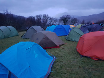 Tent on landscape against blue sky