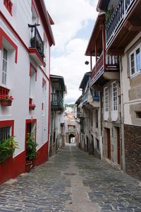 Narrow alley amidst buildings in city