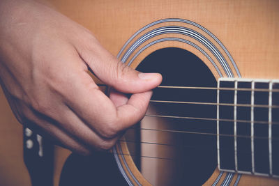 Close-up of hand playing guitar