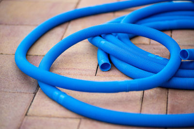 High angle view of garden hose on footpath