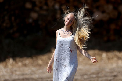 Young woman wearing hat while standing on land