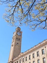 Low angle view of clock tower against building