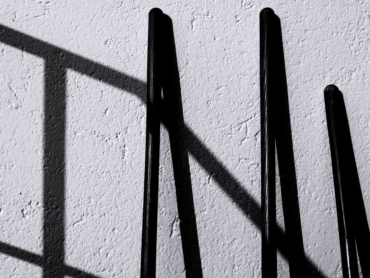 shadow, wall - building feature, sunlight, no people, day, focus on shadow, wall, nature, built structure, outdoors, architecture, close-up, pattern, sunny, textured, black color, metal, graffiti, creativity, simplicity