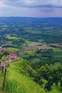 Scenic view of landscape and houses against sky