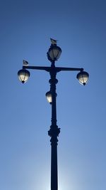 Low angle view of street light against sky