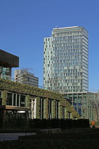 Low angle view of modern building against clear blue sky