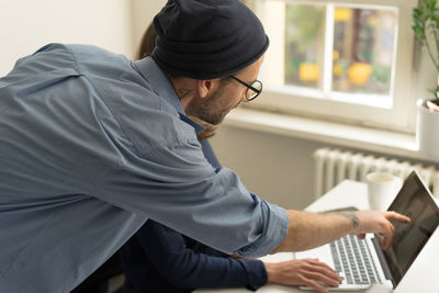 Midsection of man using mobile phone