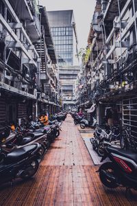 Motorcycles parked amidst buildings in city