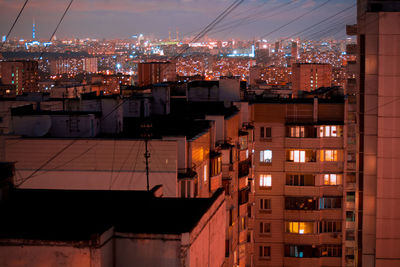 Illuminated buildings in city against sky at night
