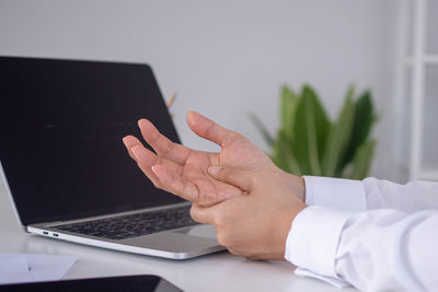Midsection of man using mobile phone