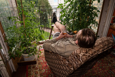 Rear view of woman lying down on floor