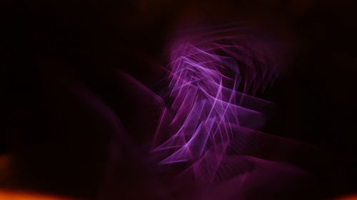 Close-up of light painting against black background