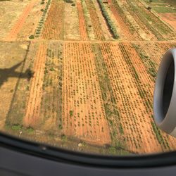 Aerial view of field seen through airplane window