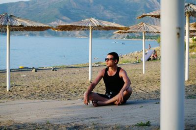 Portrait of young man sitting on beach