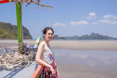 Portrait of smiling young woman on beach