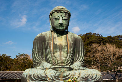 Statue of buddha against sky