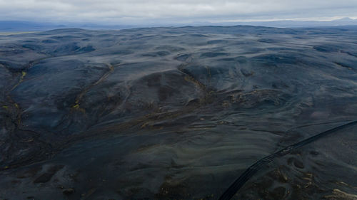 High angle view of land and sea against sky