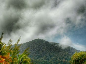 Scenic view of mountains against cloudy sky