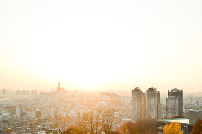 Buildings in city against clear sky