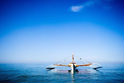 Boat sailing in sea against sky