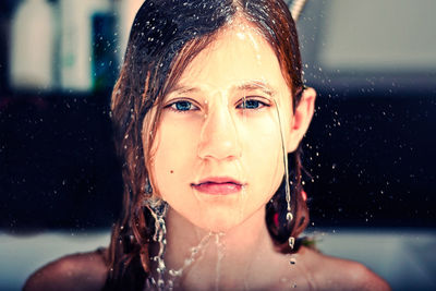 Close-up portrait of wet young woman 