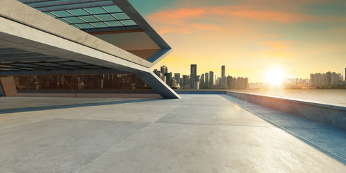 Modern building against sky during sunset