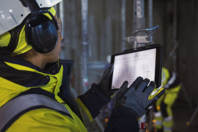 Engineer at building site using digital tablet