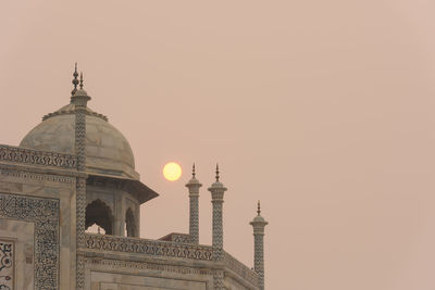 Traditional building against sky during sunset