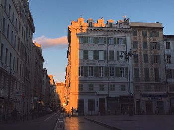 Buildings in city at sunset