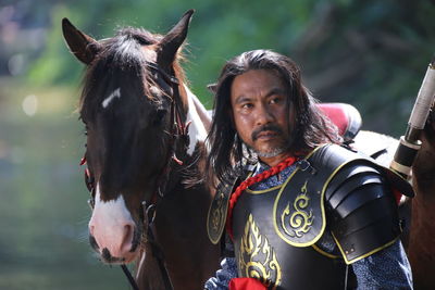 Man in warrior costume with horse