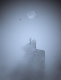 Digital composite image of moon against sky at night