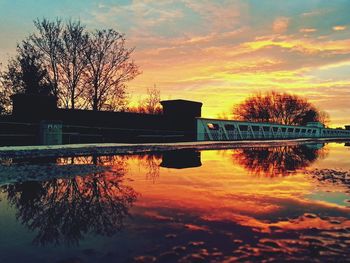 Bridge over river at sunset