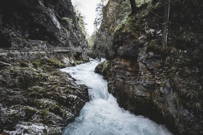 Scenic view of river flowing through rocks